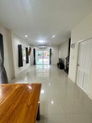 Spacious living area with glossy tile flooring and large windows