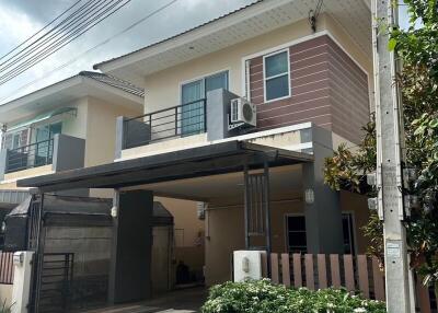 Two-story house with carport and balcony
