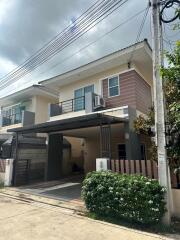 Two-story house with carport and balcony