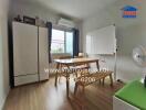 Dining area with table, chairs, whiteboard, air conditioning, and a wardrobe