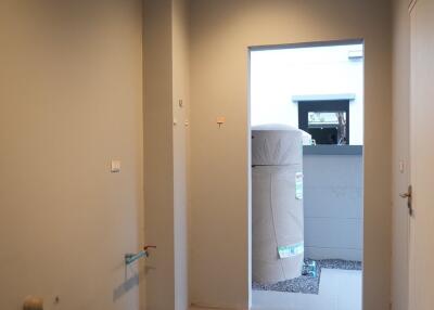A empty utility room with a doorway leading outside