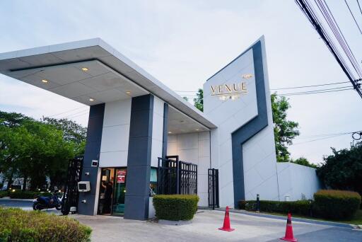 Modern entry gate to a residential area with security and greenery