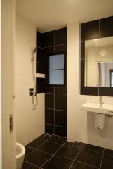 Modern bathroom with shower, sink, and toilet