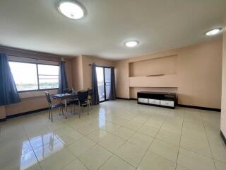 Spacious living room with dining area and modern lighting