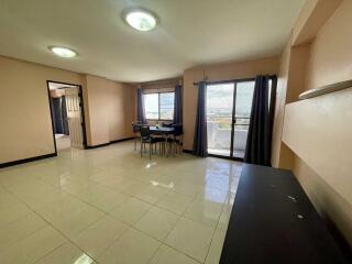 Spacious living room with large windows and balcony access