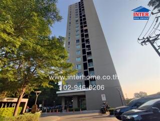 Tall apartment building with street view and trees