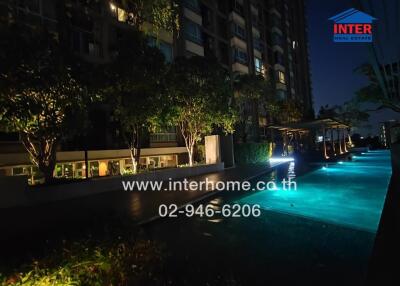 Apartment building with swimming pool at night
