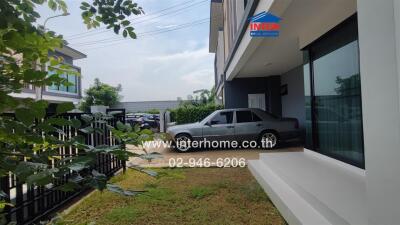 Front yard view with a parked car beside the house