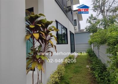 Exterior view of a modern building with windows and garden