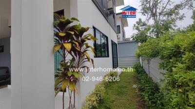 Exterior view of a modern building with windows and garden