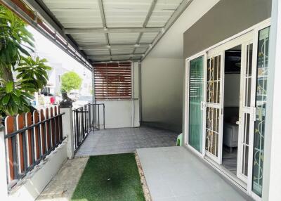 Covered outdoor space with tiled flooring and sliding glass doors