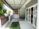 Covered outdoor space with tiled flooring and sliding glass doors