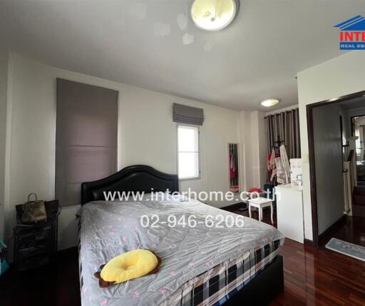 Modern bedroom with a large bed and wooden floor