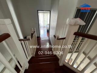 Staircase leading to an entryway with a glass door