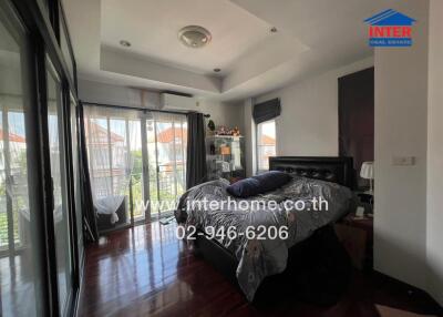 Bedroom with glass doors and hardwood floors