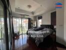 Bedroom with glass doors and hardwood floors