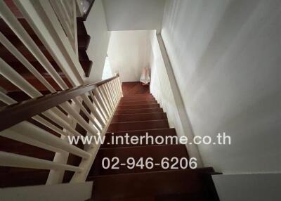 Wooden staircase with white railings