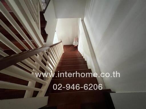 Wooden staircase with white railings