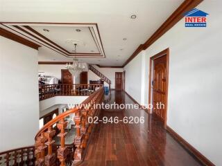 Elegant hallway with wooden floors and a chandelier