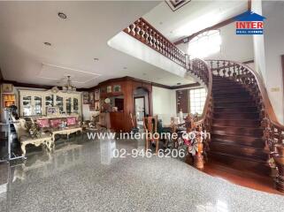 Elegant main living space with ornate staircase