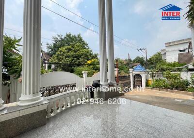 Front outdoor view of residential property with columns and gate