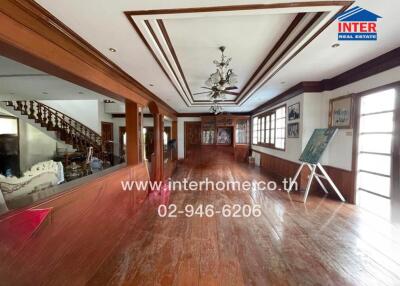 Spacious living room with hardwood floors and decorative ceiling