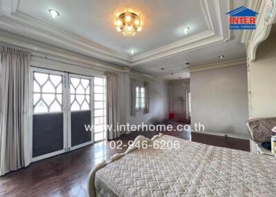 Spacious bedroom with large windows and balcony access