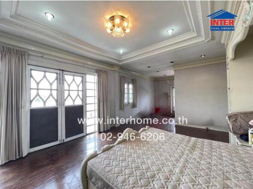 Spacious bedroom with large windows and balcony access