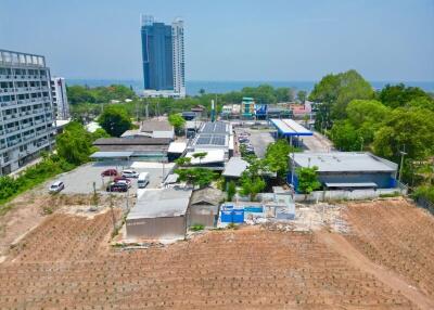 Vacant land with nearby buildings and a view of the sea