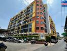 Large multi-story residential building with parked motorcycles in front