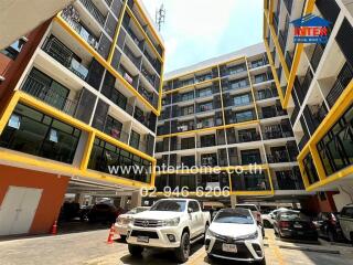 Exterior view of an apartment building with a parking lot