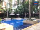 Outdoor communal pool area with palm trees