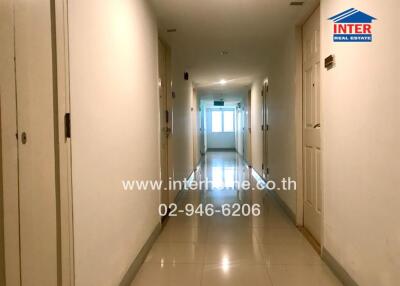 Apartment hallway with tiled floors and doors on either side