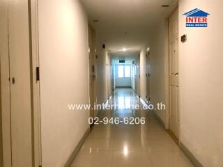 Apartment hallway with tiled floors and doors on either side