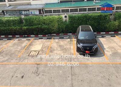 Outdoor parking area with a single parked car