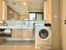 Modern bathroom with a large mirror and a washing machine