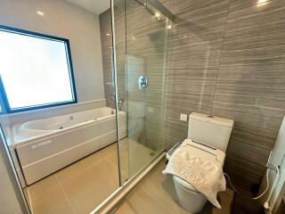 Modern bathroom with bathtub and walk-in glass shower