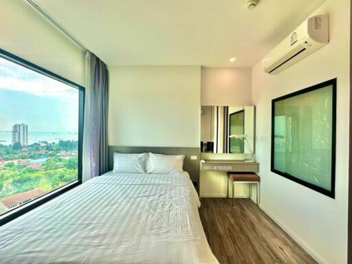 Modern bedroom with a large window and ocean view