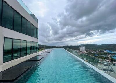 Rooftop infinity pool with city and mountain view