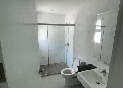 Modern bathroom with shower, sink, and toilet