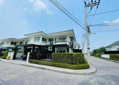 Modern two-story house with a well-maintained lawn and driveway