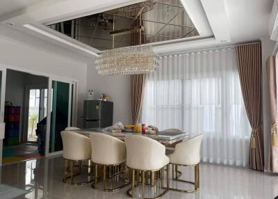 Modern dining room with elegant chandelier and dining table with chairs