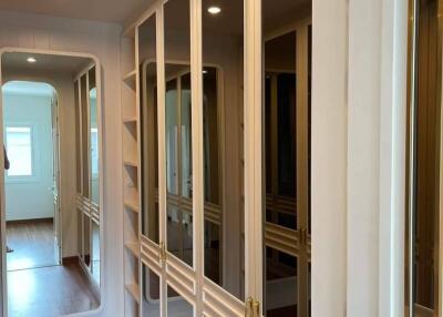Spacious walk-in closet with full-length mirrors and ample storage space