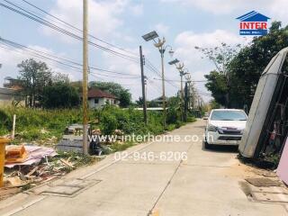 Street view with nearby houses and parked vehicles