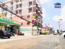 Street view with commercial building and neighboring apartments