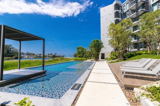 Modern condominium with a pool and lounge chairs