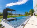 Outdoor swimming pool with shaded lounging area by the trees on a sunny day