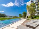 Modern apartment building with pool and lounge area