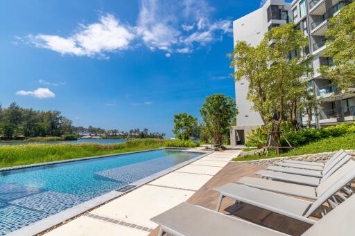 Modern apartment building with pool and lounge area