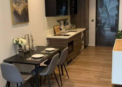 Modern kitchen and dining area with wooden flooring